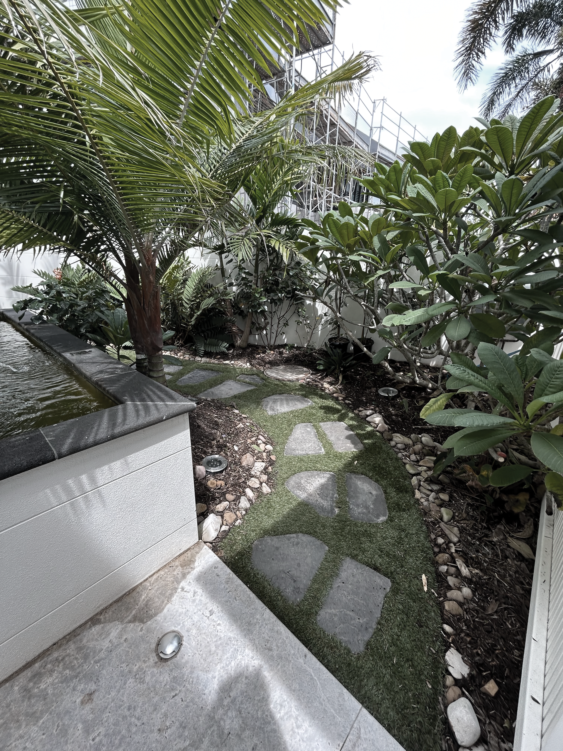 A Man is Taking a Picture of a Building With a Camera — Commercial Asset Maintenance In Caloundra, QLD