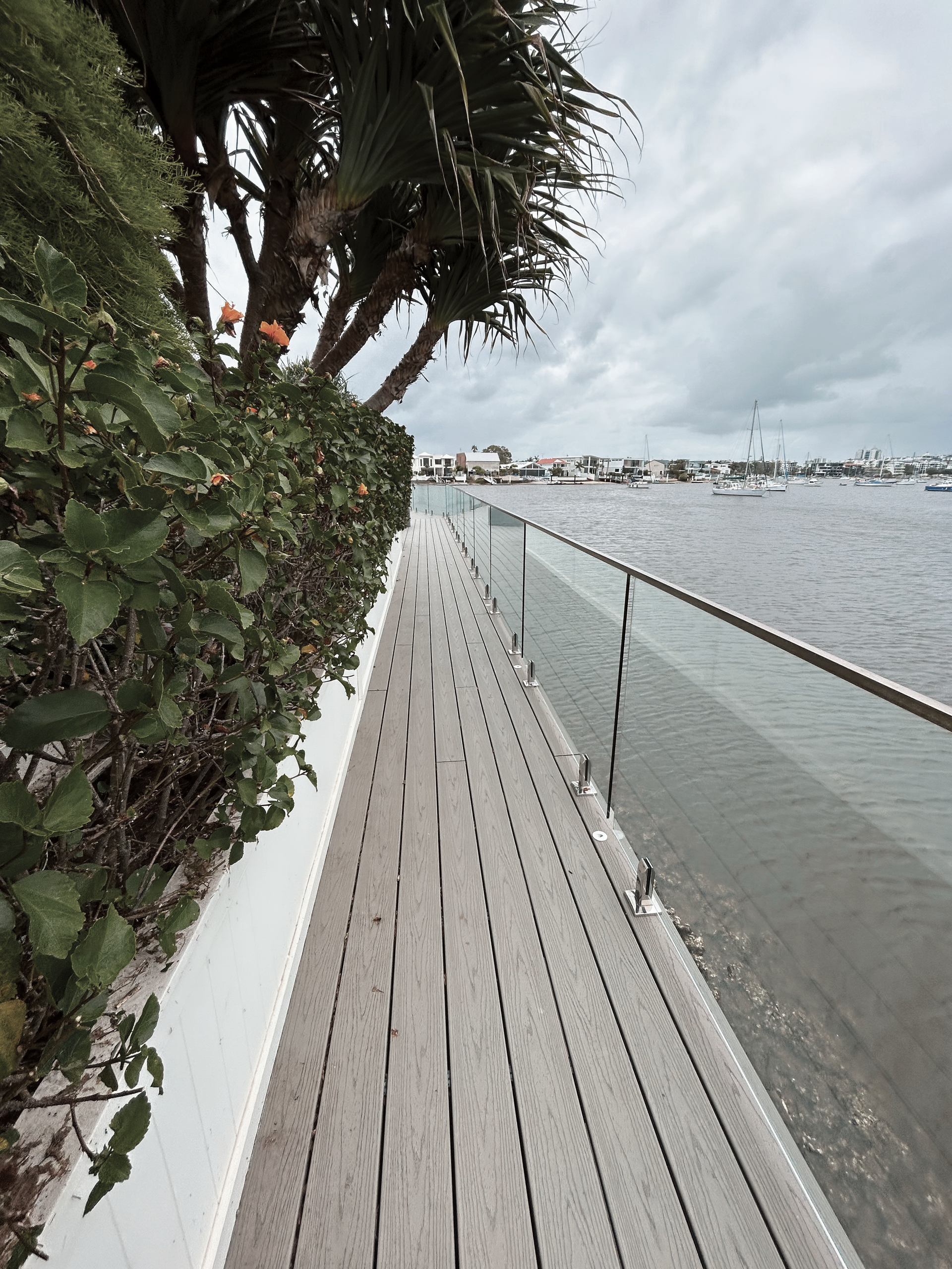 A Wooden Boardwalk Along Water — Commercial Asset Maintenance In Burpengary, QLD