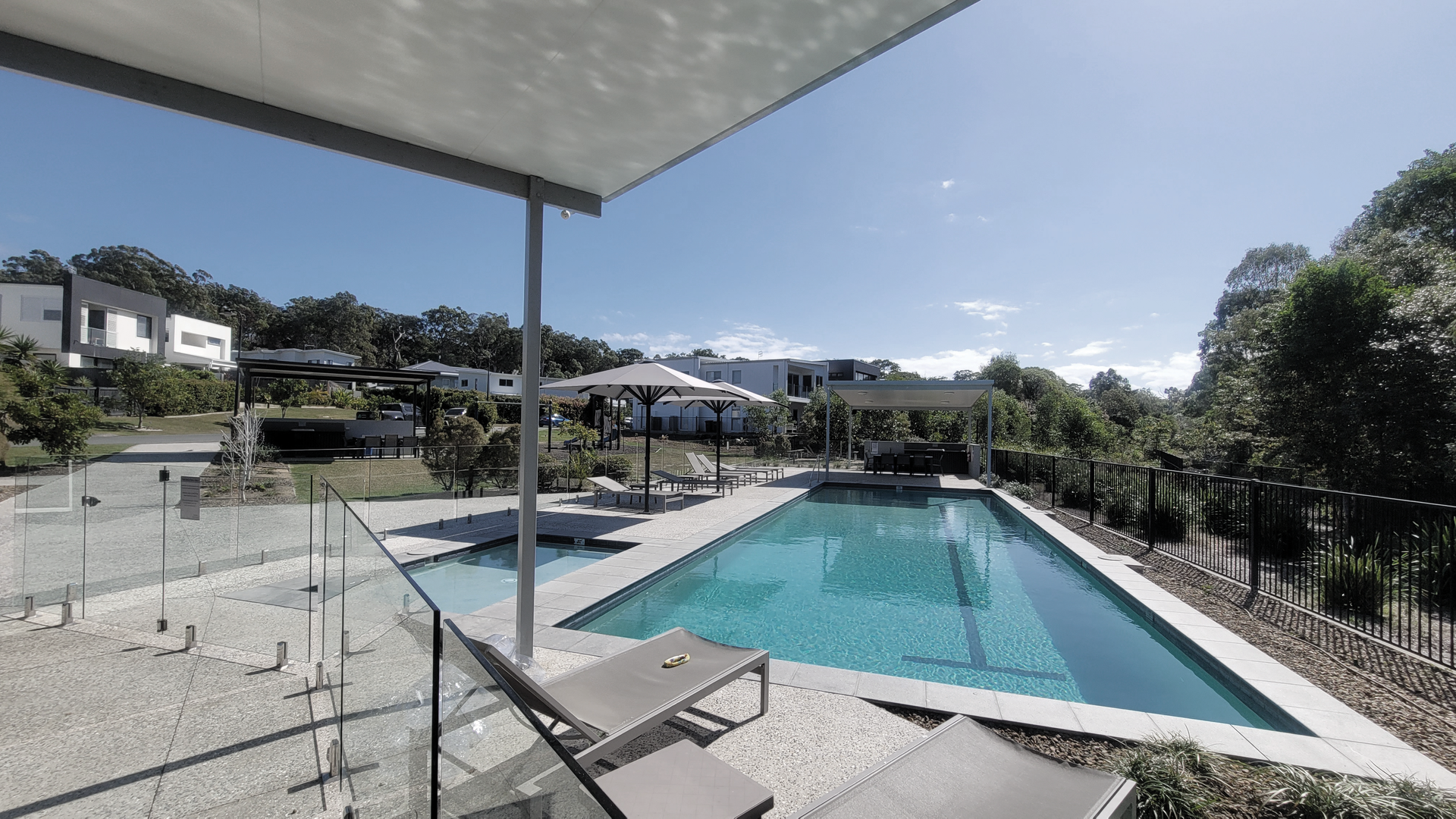 A Man is Standing Next to a Wall Holding a Hedge Trimmer — Commercial Asset Maintenance In Nambour, QLD