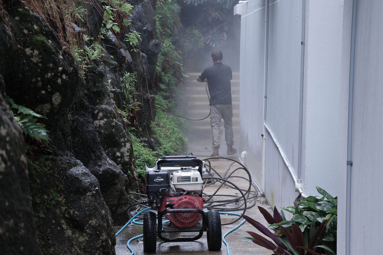 A Man Power Washing a Walkway — Commercial Asset Maintenance In Noosa, QLD