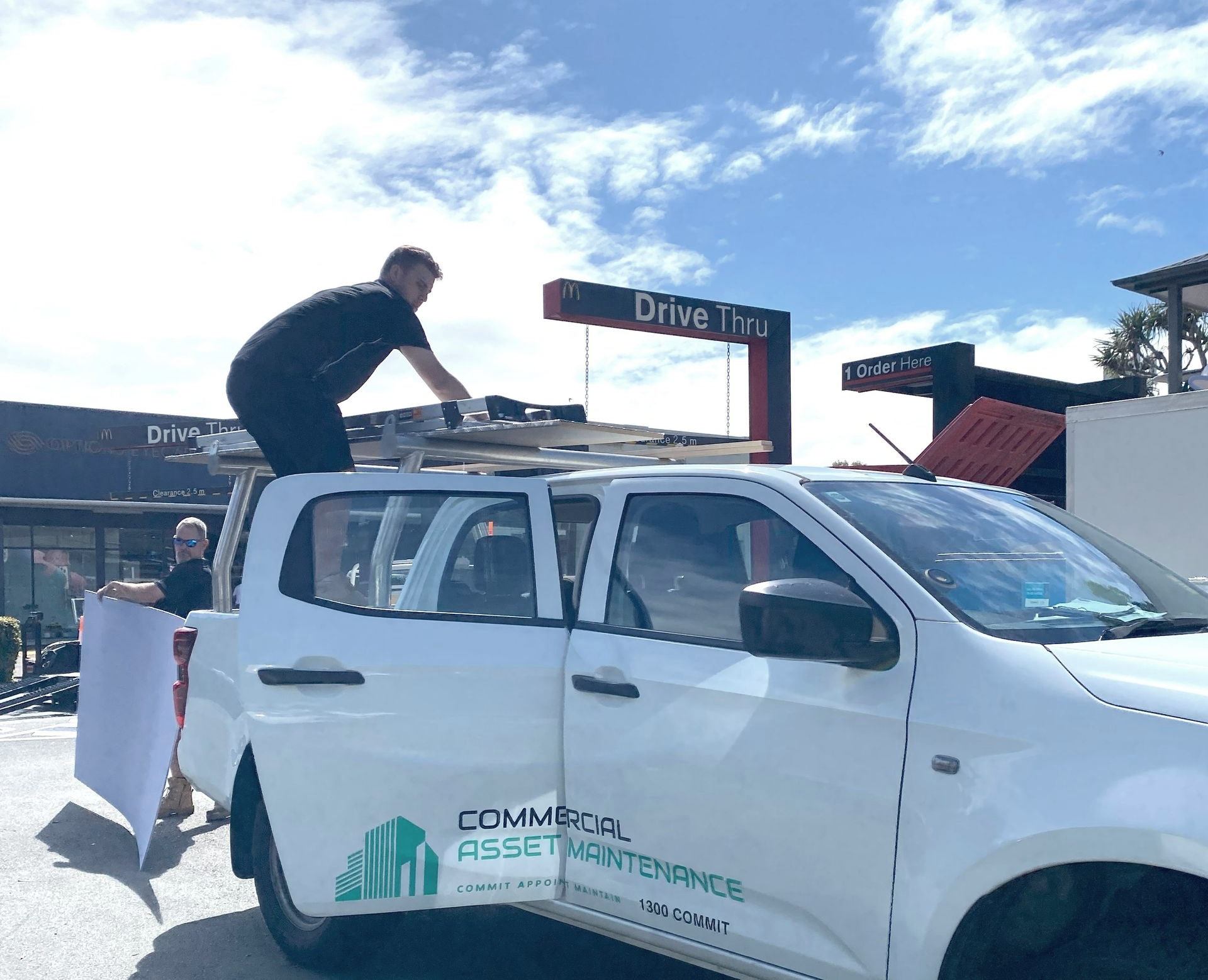 Two Men Loading Supplies onto A White Truck — Commercial Asset Maintenance In Nambour, QLD