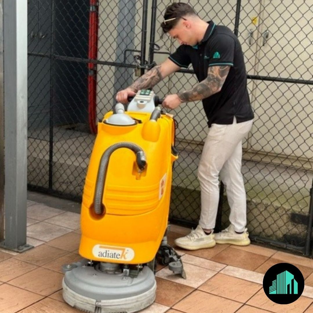 A Man Operating a Yellow Floor Cleaning Machine — Commercial Asset Maintenance In Deception Bay, QLD