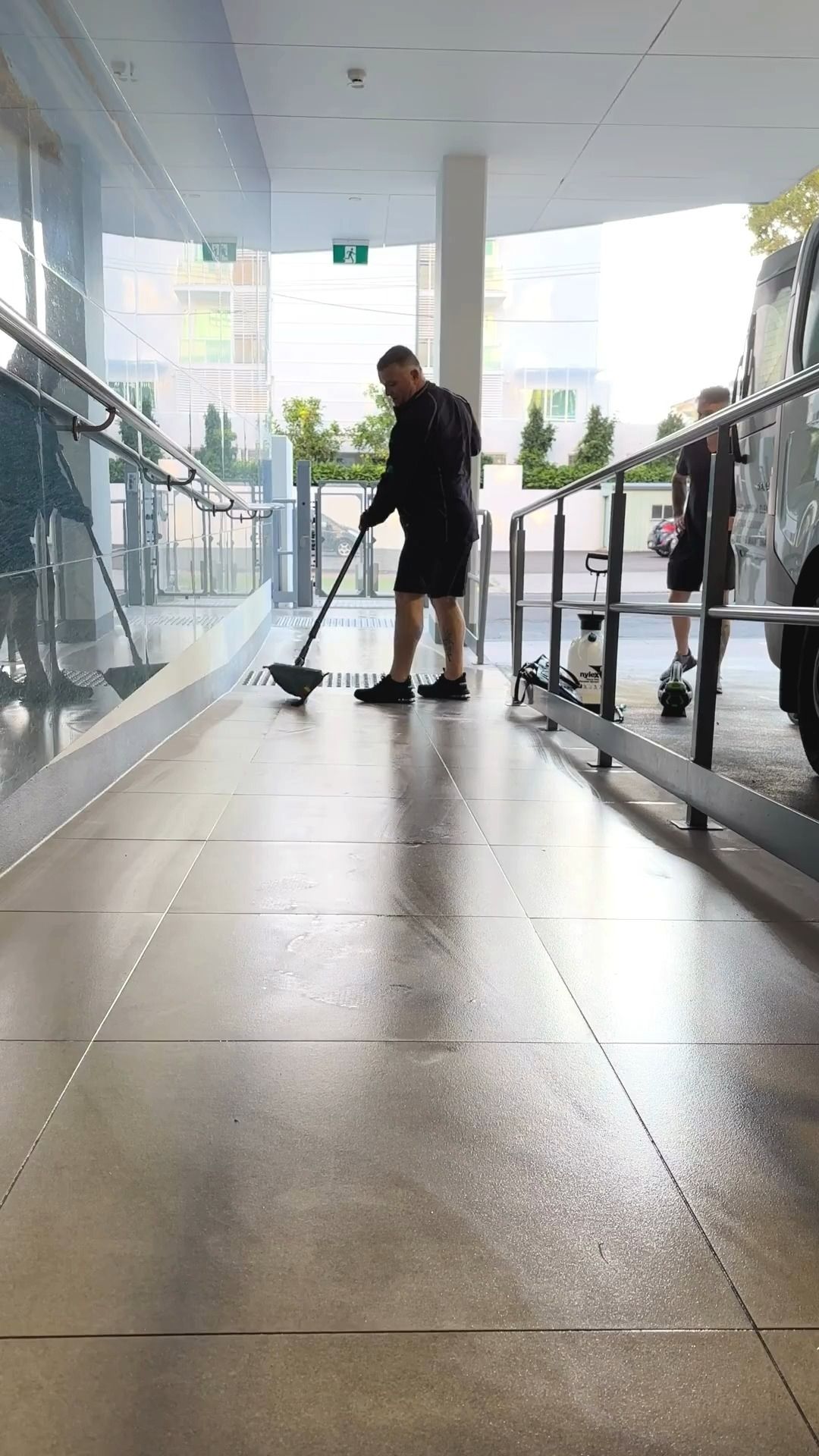 A Man Mopping a Wet — Commercial Asset Maintenance In Ipswich, QLD
