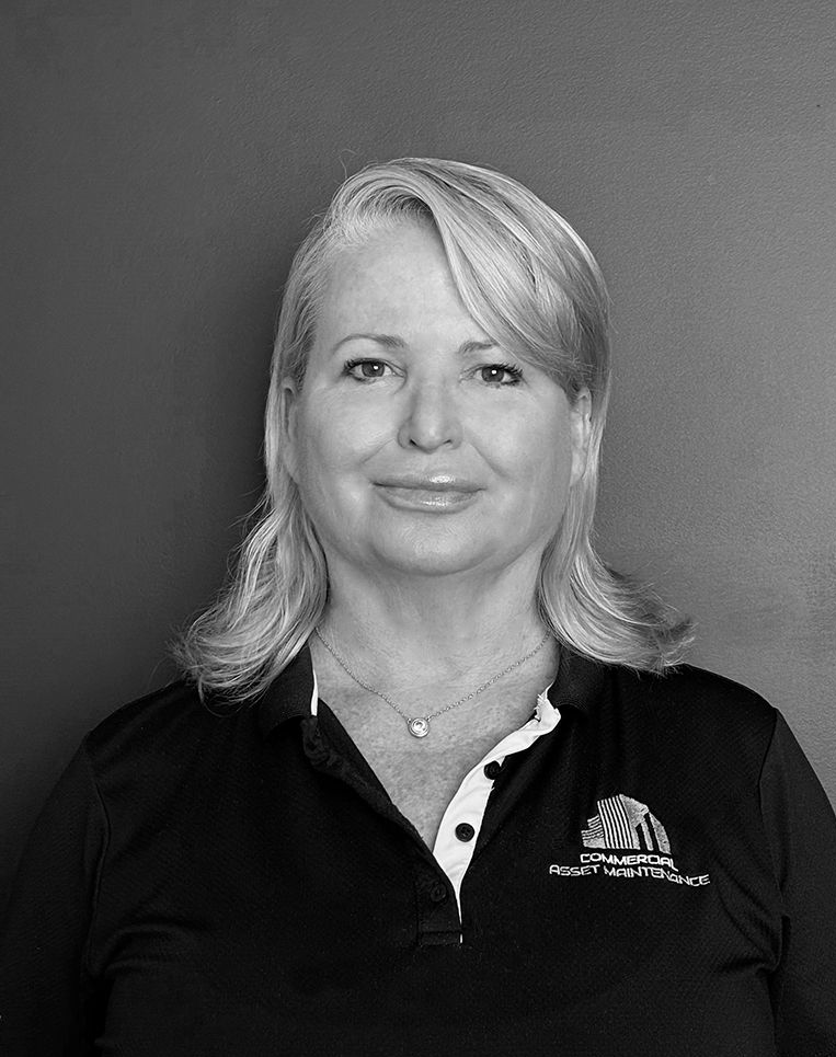 Woman with blonde hair, wearing a black collared shirt, smiling, against a plain background. — Commercial Asset Maintenance In 1Gympie, QLD