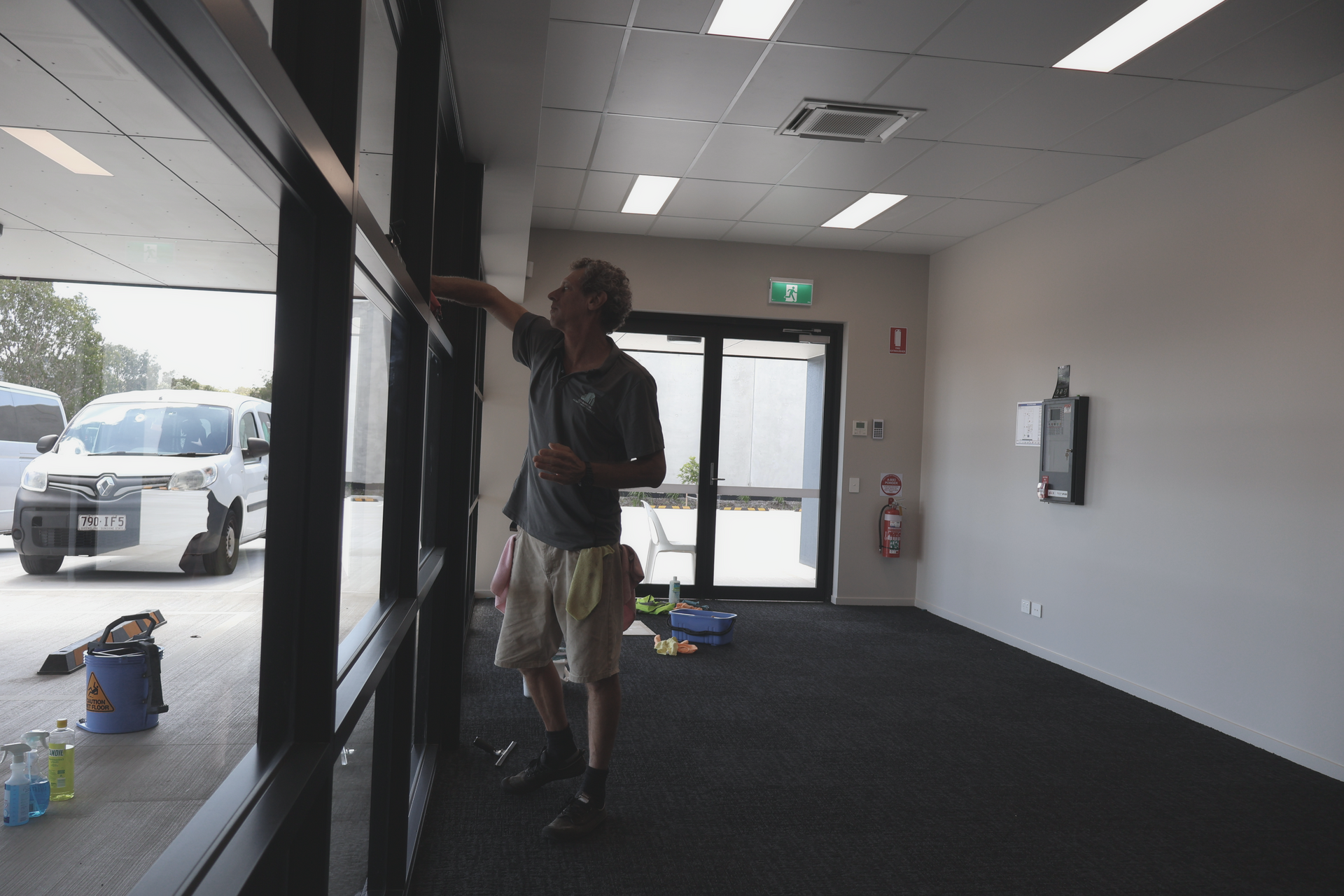 A Woman Mops a Hallway — Commercial Asset Maintenance In Coolum Beach, QLD