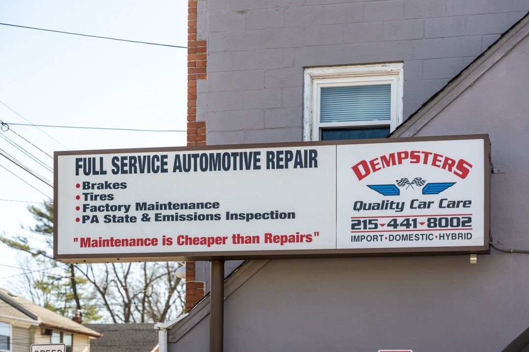 Sign for Dempsters auto repair, offering full service, including brakes, tires, and inspections; phone number provided.
