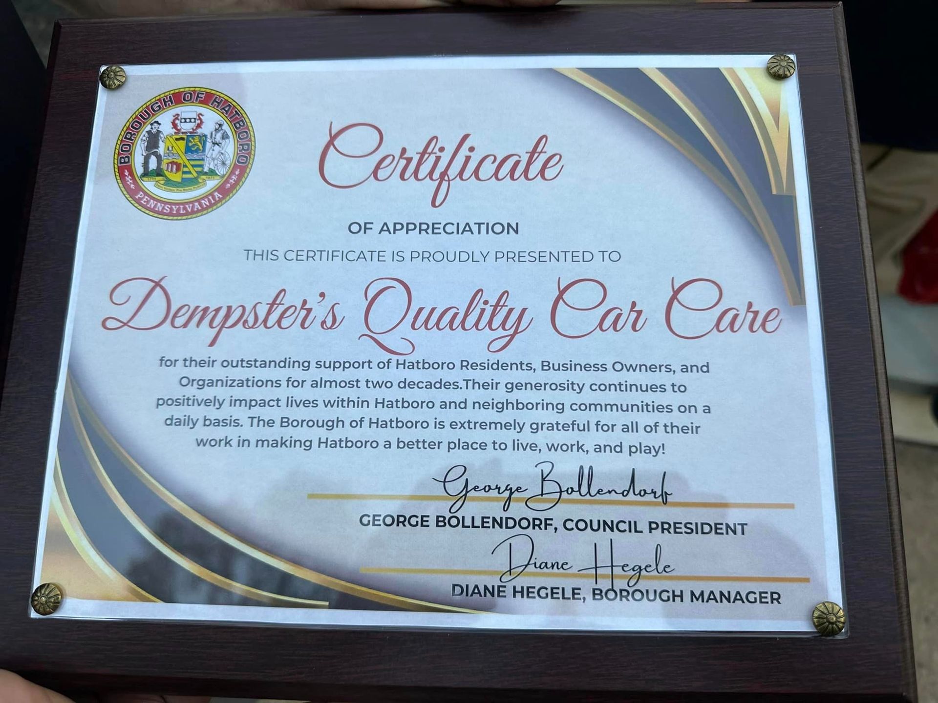 Certificate of appreciation for Dempster's Quality Car Care, presented by George Mollendorf, Council President.