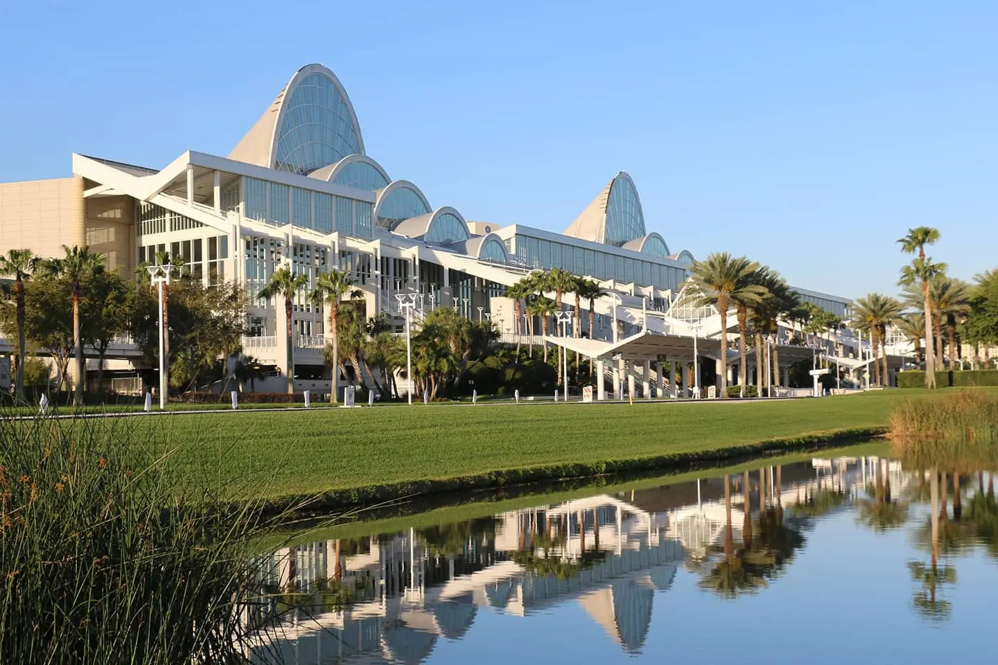 A large building is reflected in a body of water.