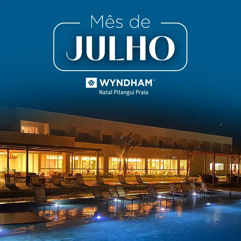 Hotel pool at night with “Mês de Julho” and Wyndham Natal Pitangui Praia branding