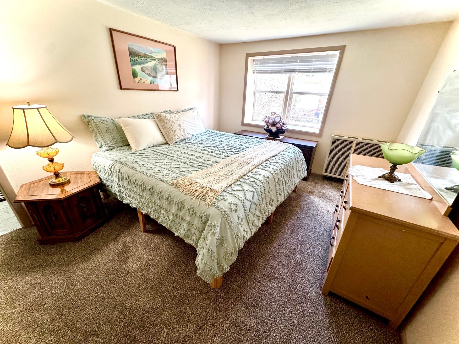Bedroom with queen bed and natural light at Stucco Casa Antonito