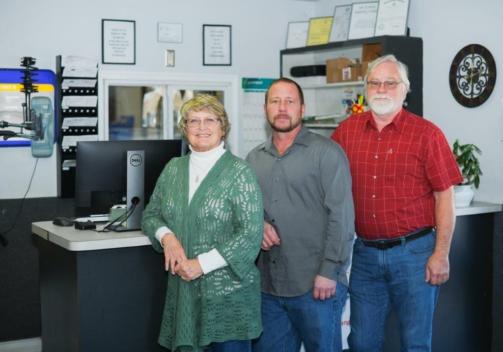 the owners standing in front of the service desk
