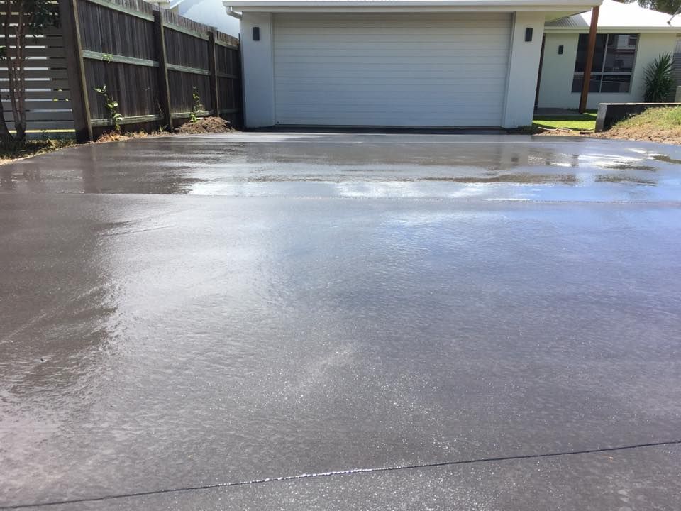 Freshly Sealed Gray Concrete Driveway — Construction 33 in Sunshine Coast, QLD