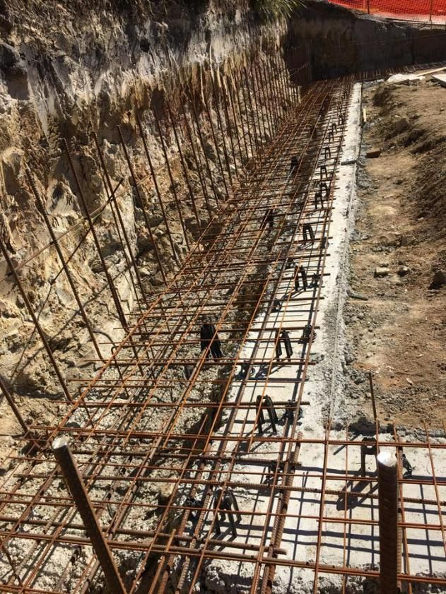 Fence is Being Built in the Dirt Next to a Rock Wall — Construction 33 in Coolum Beach, QLD