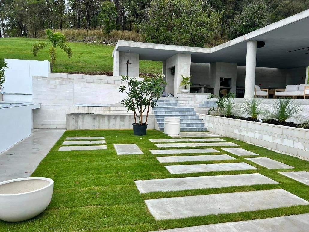 House With a Lush Green Lawn and Concrete Walkways Leading to It — Construction 33 in Coolum Beach, QLD