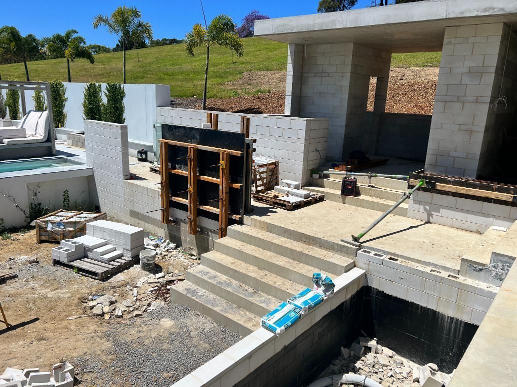 A Building Under Construction With a Pool in the Background — Construction 33 Concreting in Gympie, QLD
