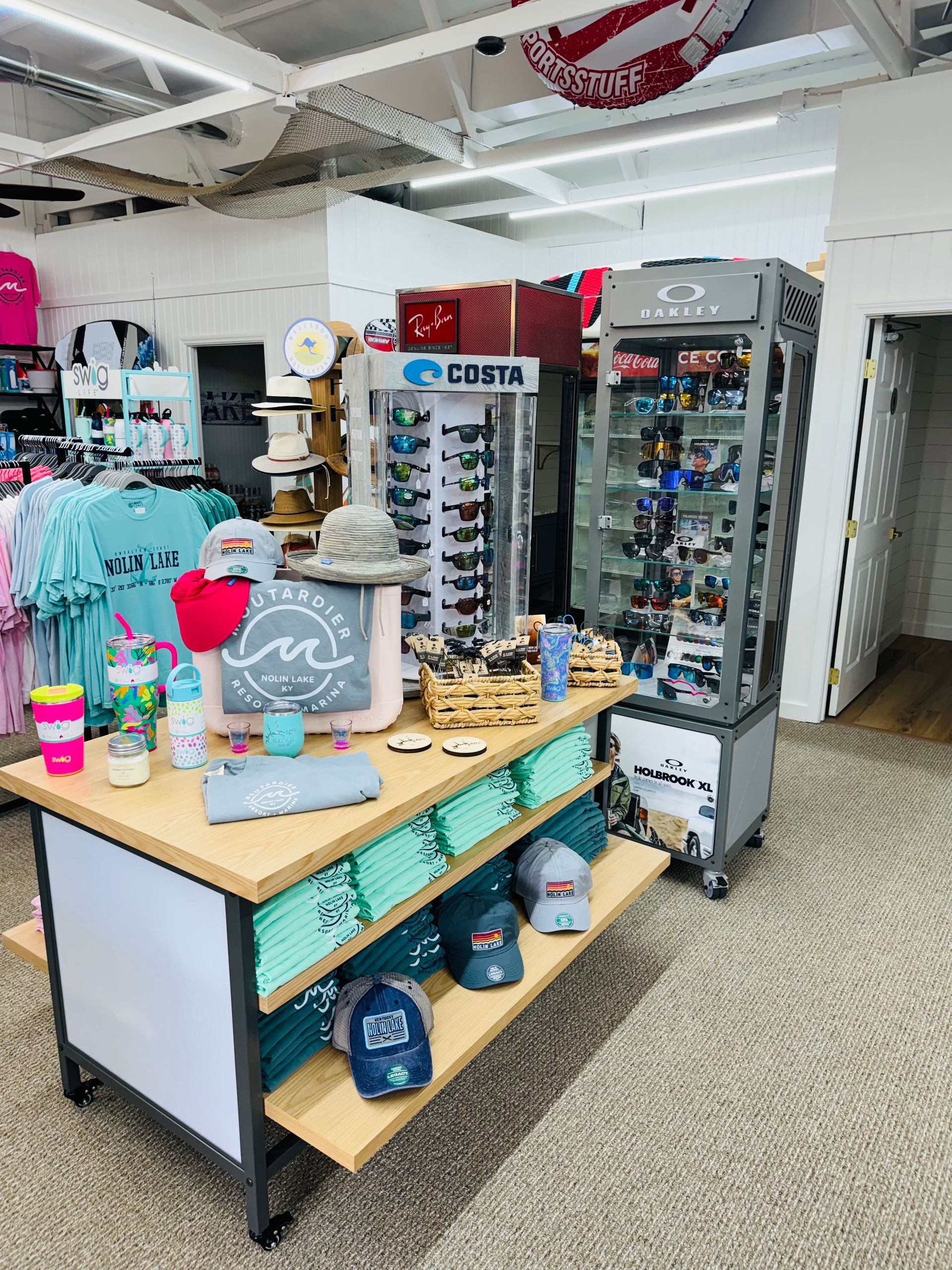 A store filled with lots of clothes and sunglasses.