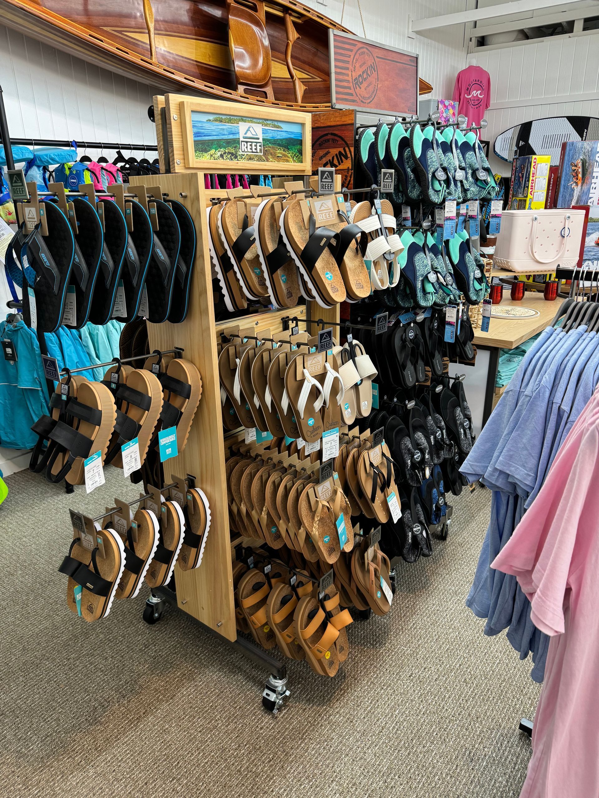 A store filled with lots of sandals and shirts.