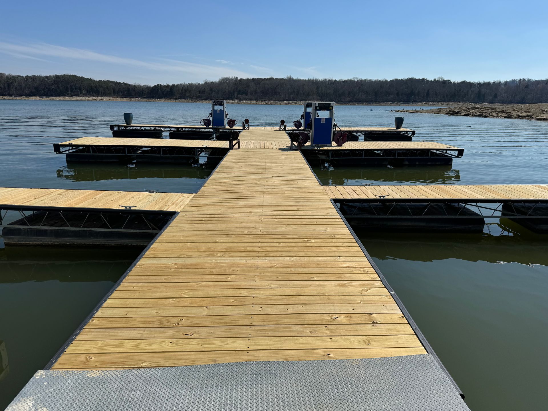 A wooden dock is sitting in the middle of a lake.