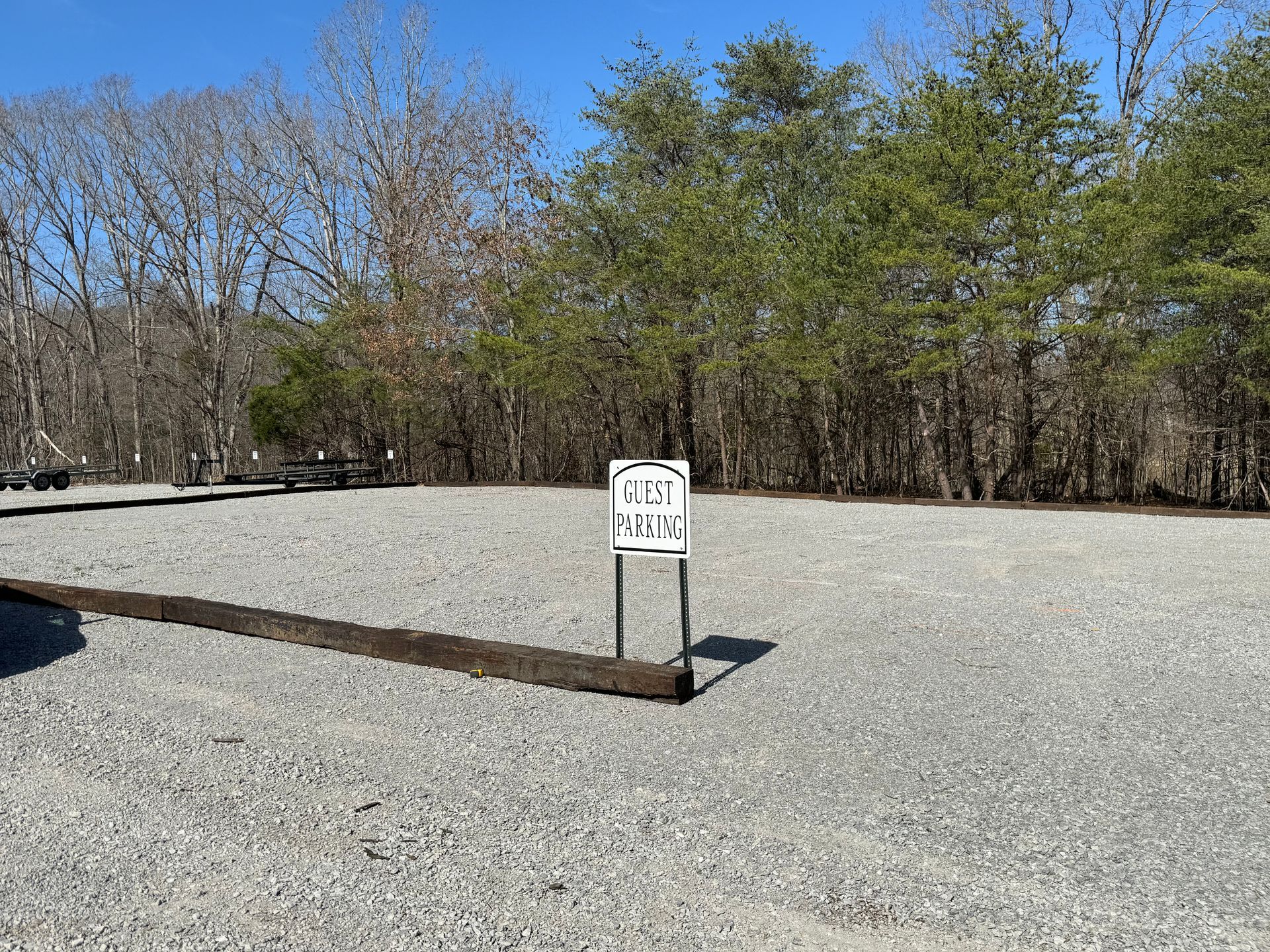 A gravel area with a sign in the middle of it.