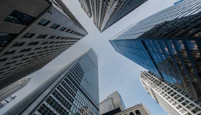 Looking up at a group of tall buildings in a city