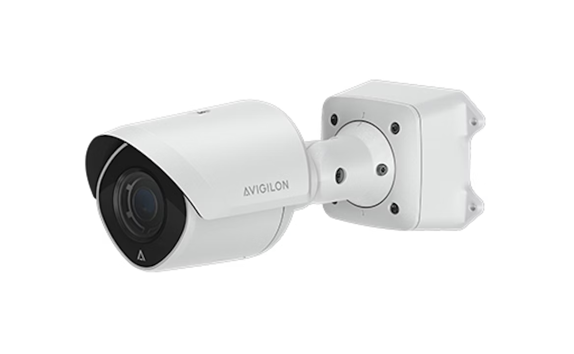 White security camera mounted on a wall bracket.