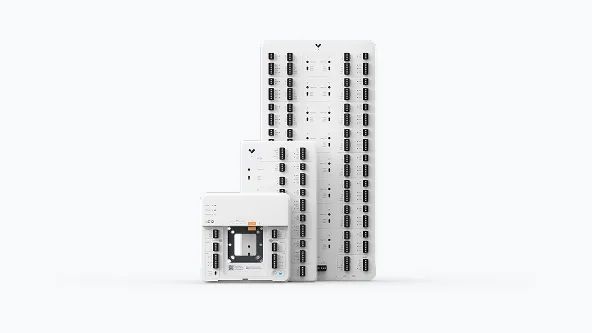 White modular panels of varying sizes, stacked. Smallest panel holds a rectangular component.