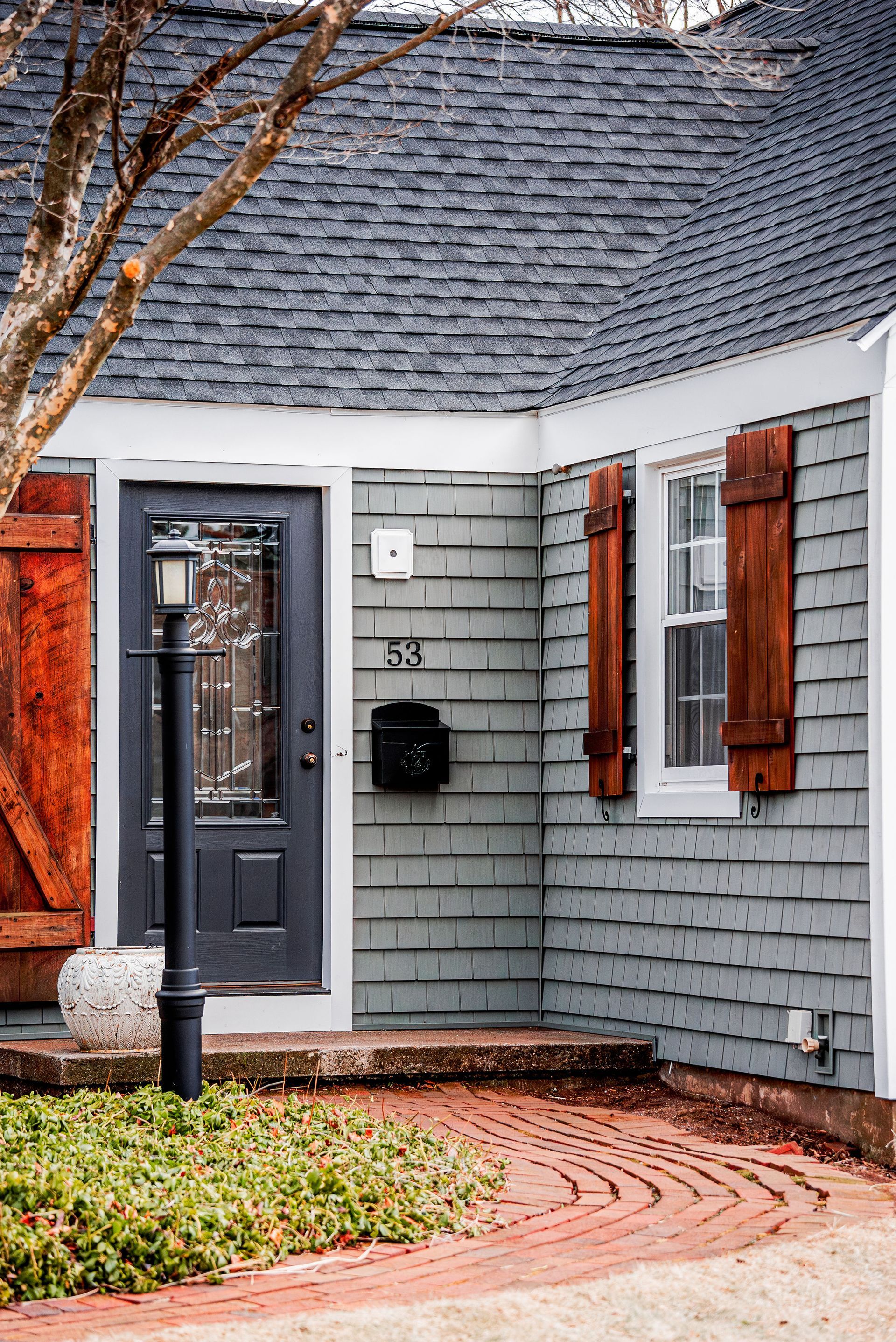 Gray house with dark door, address