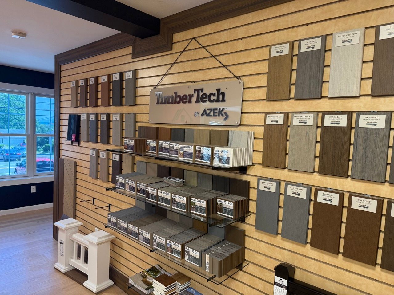 Showroom wall with TimberTech AZEK decking samples on display racks