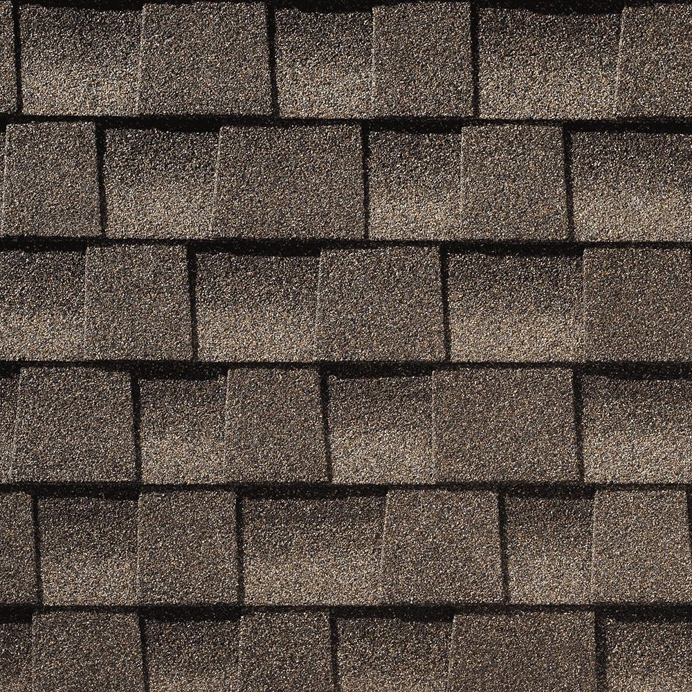 Brown asphalt shingle roof, close-up textured pattern.