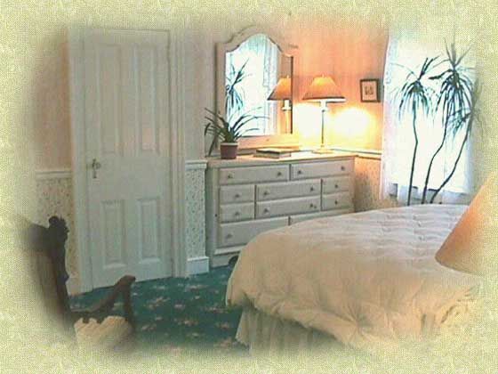 A bedroom with a bed dresser and mirror