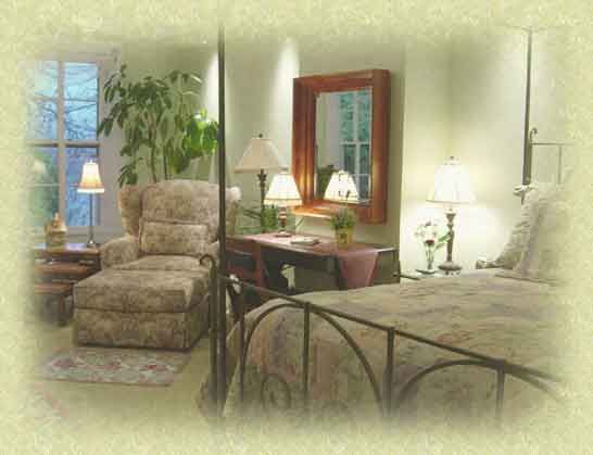 A bedroom with a bed , chair , desk and mirror