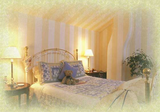 A bedroom with a bed and a teddy bear on it
