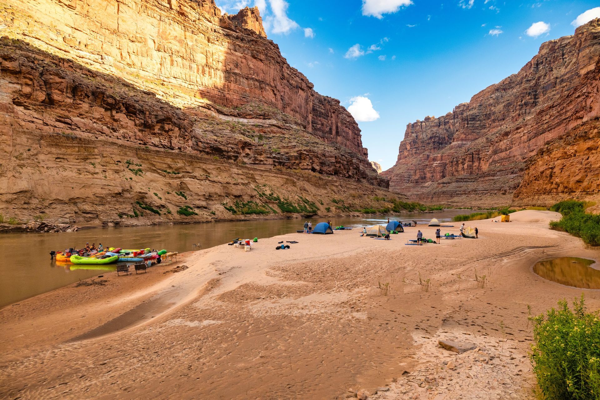 Rafts and camping equipment on a broad beach in Cataract Canyon