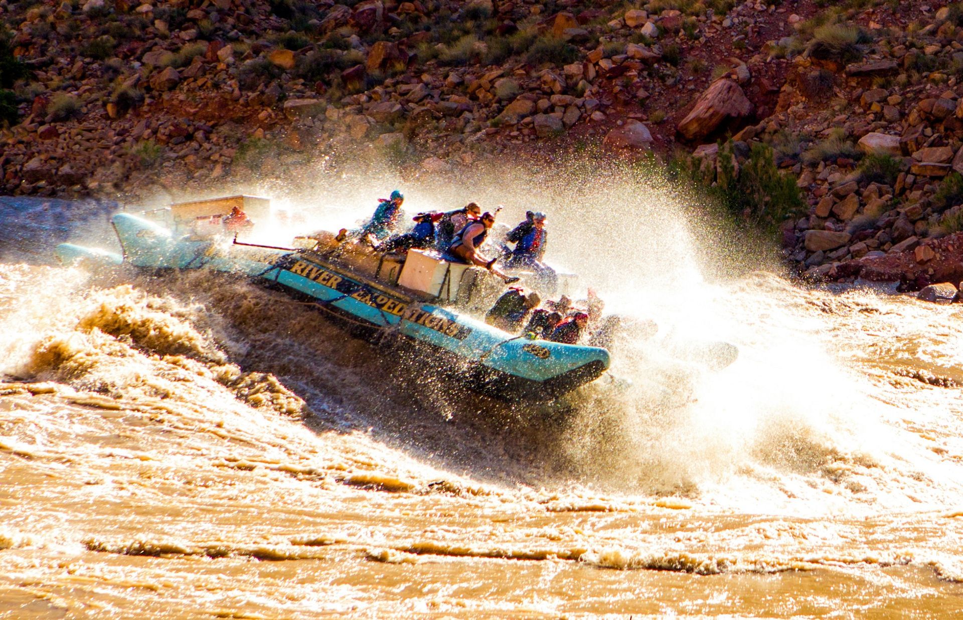 A J-Rig raft descends a large wave in Cataract Canyon