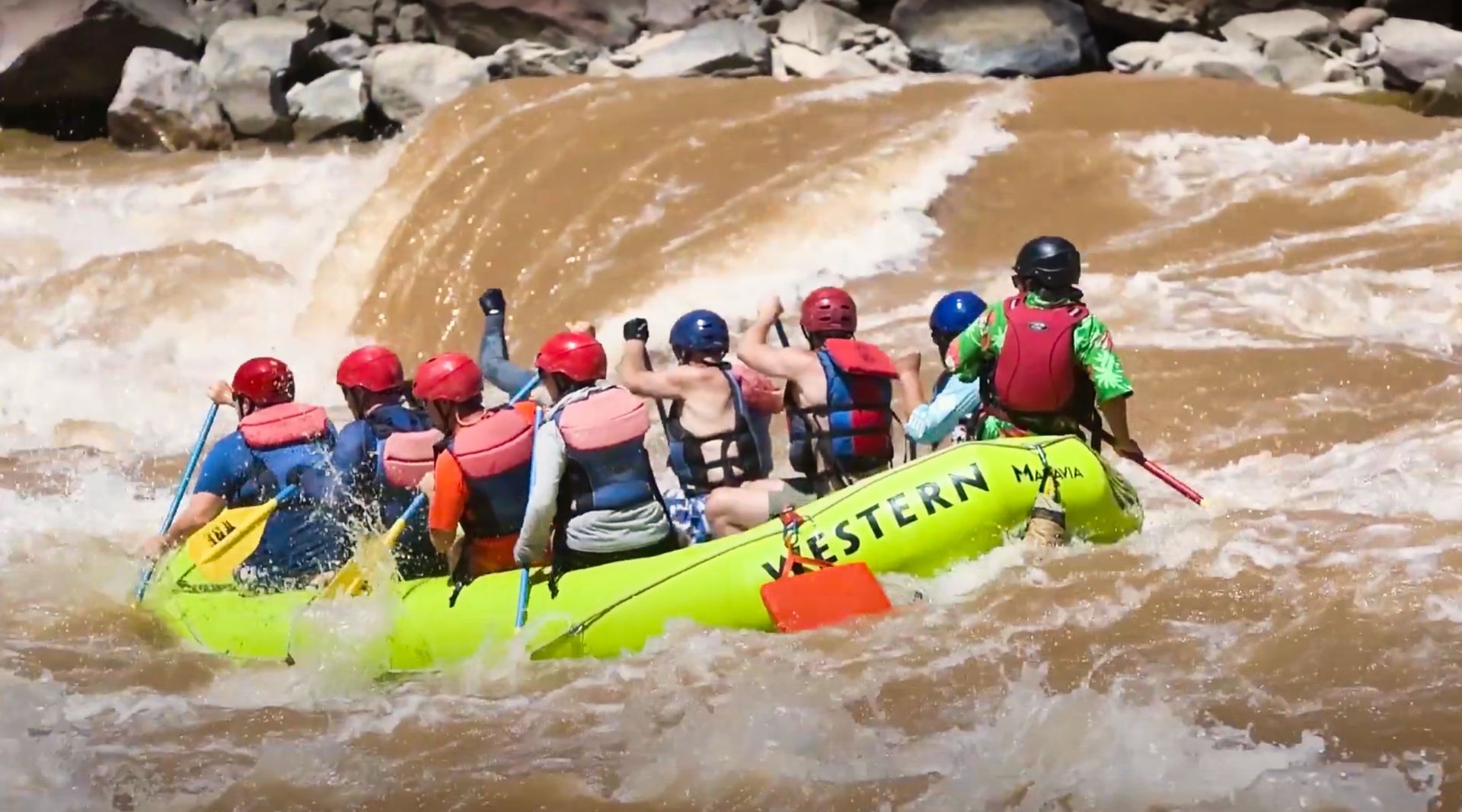 A lime green paddleboat enters into Big Drop 2 rapid just below Little Niagra.