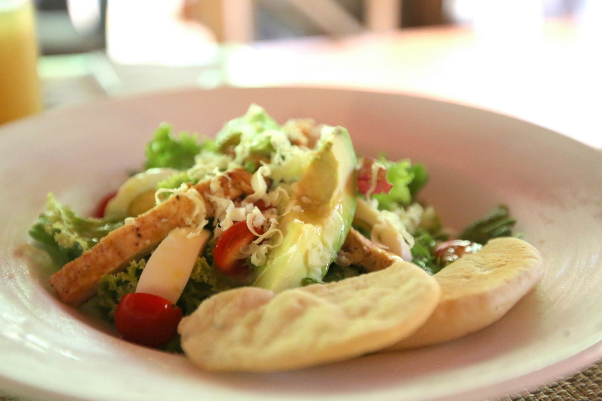 A plated meal served with fresh avocado and vegetables