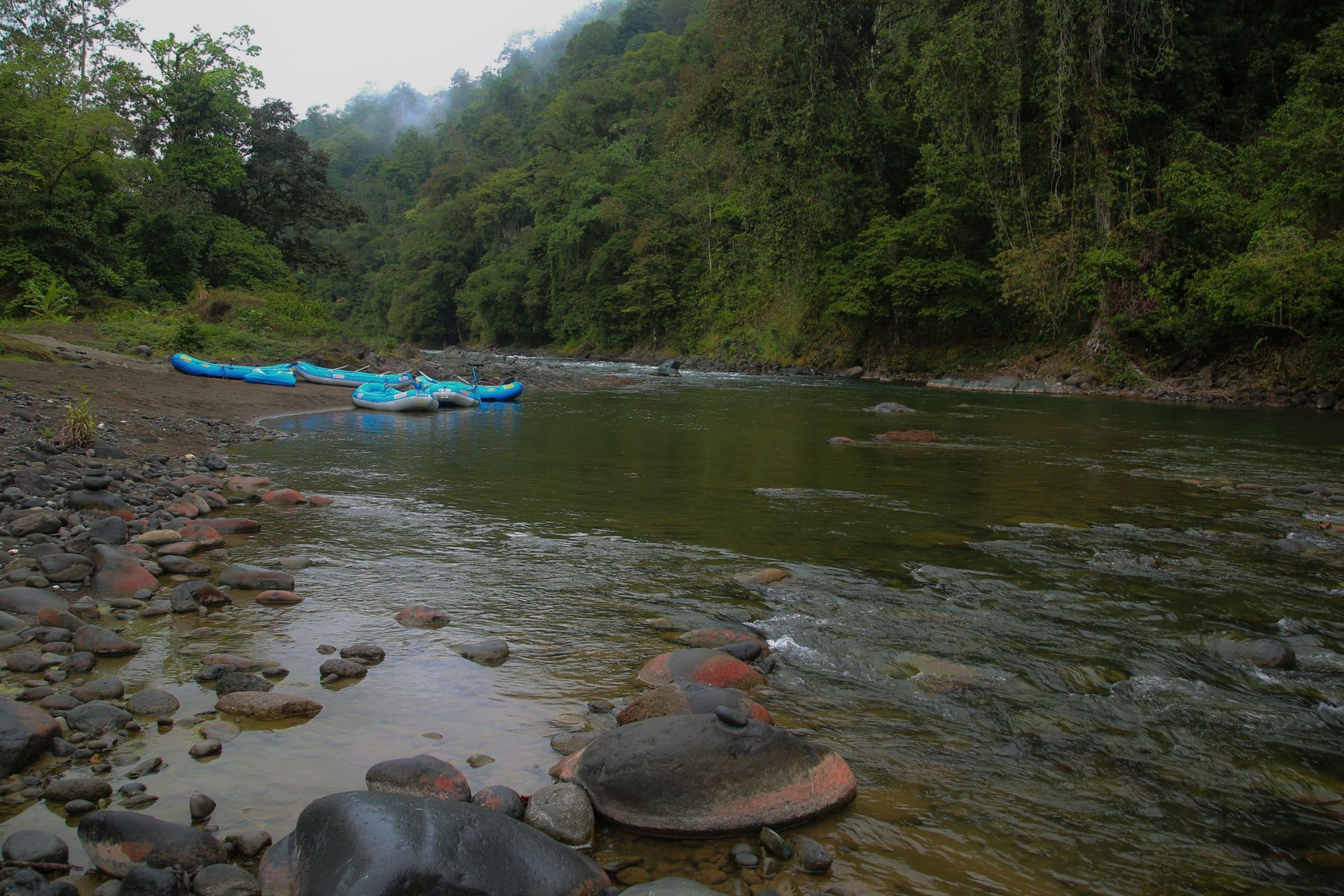 A raft beside a rocky bank on the Pacuare River