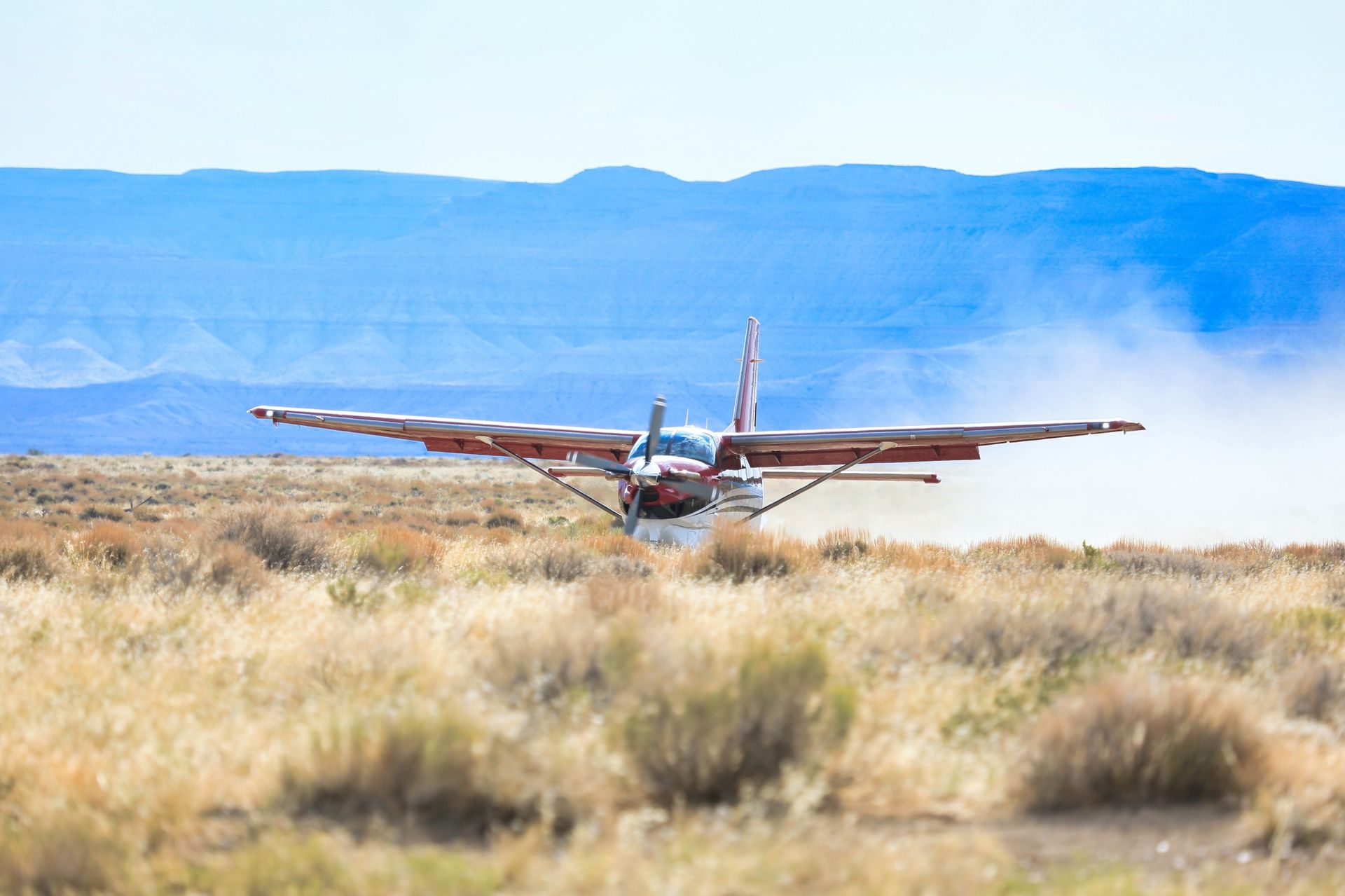 Small plane beside a remote canyon airstrip