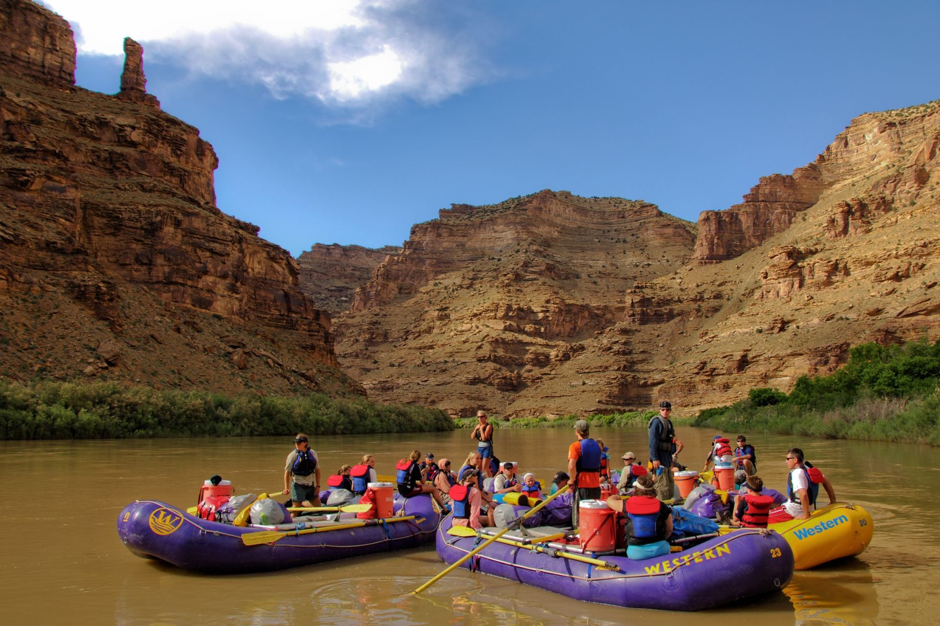Rafts drift together in a flotilla on calm water of the Green River in upper Desolation Canyon.