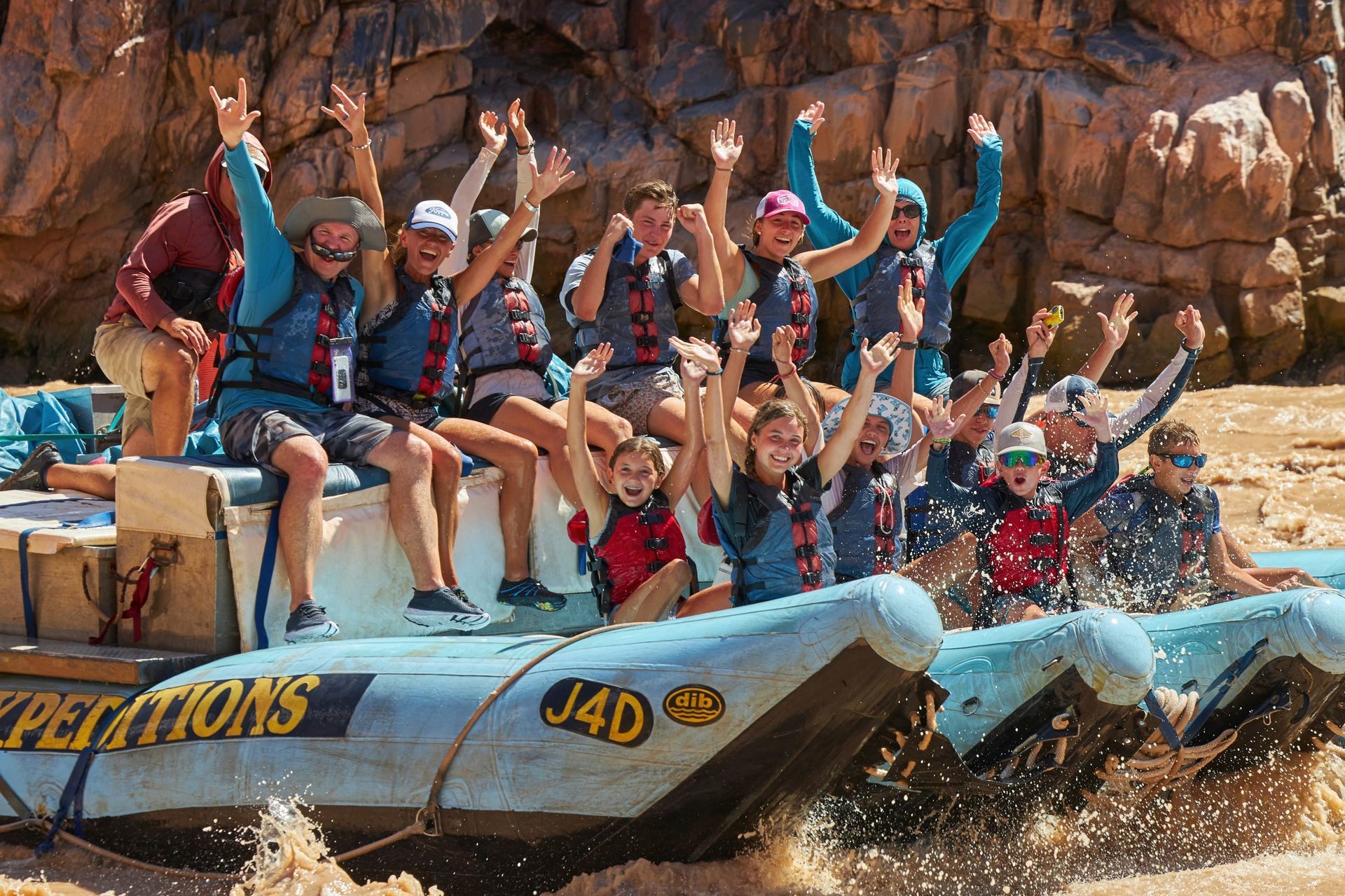 A group cheers from the front of a J-Rig raft
