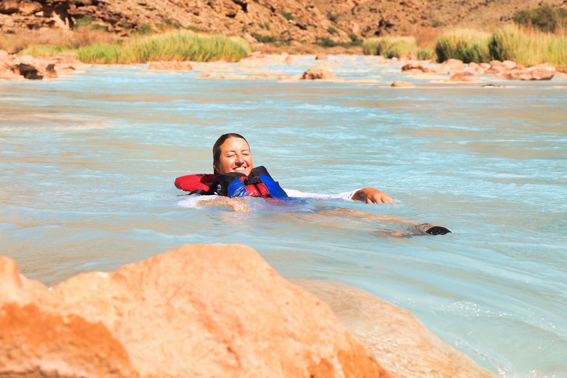 Guests float in the warm turquoise water where the Little Colorado meets the Colorado River