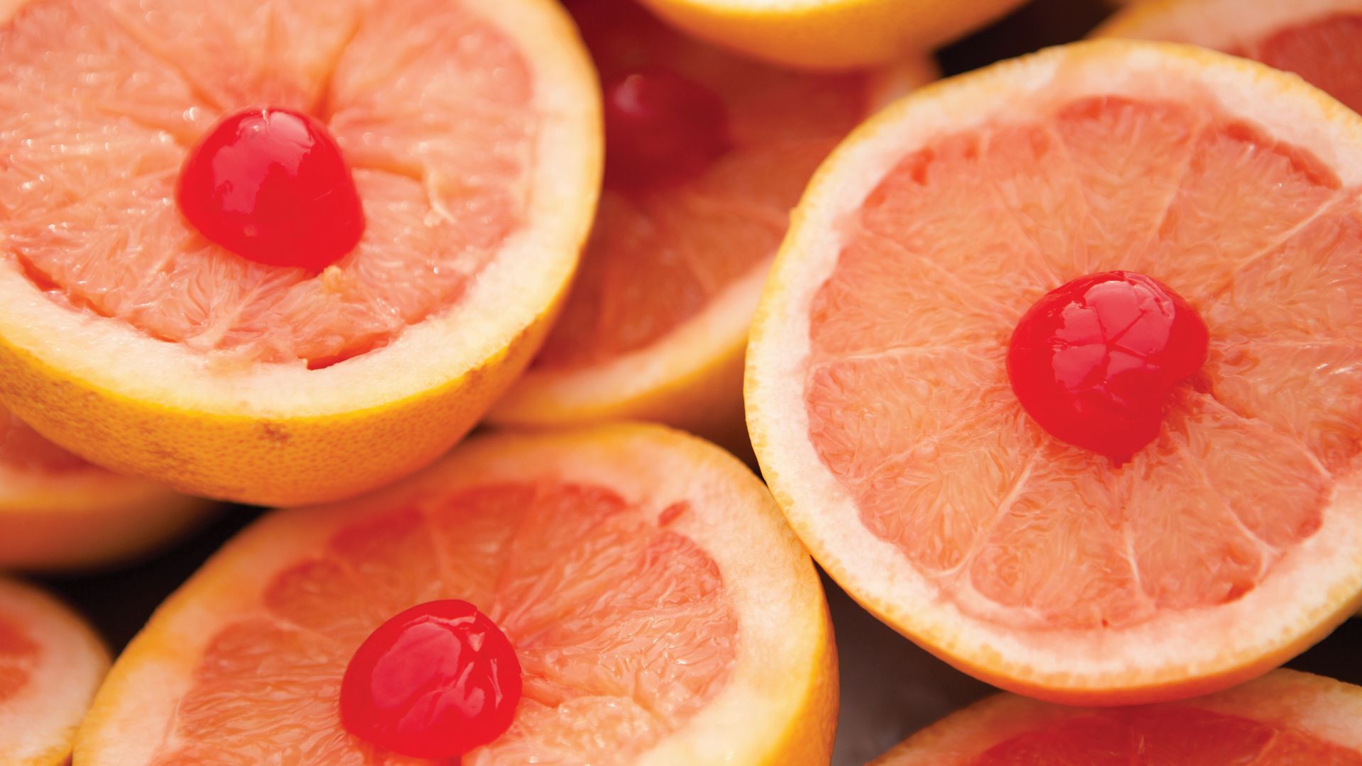 Halved grapefruit topped with cherries