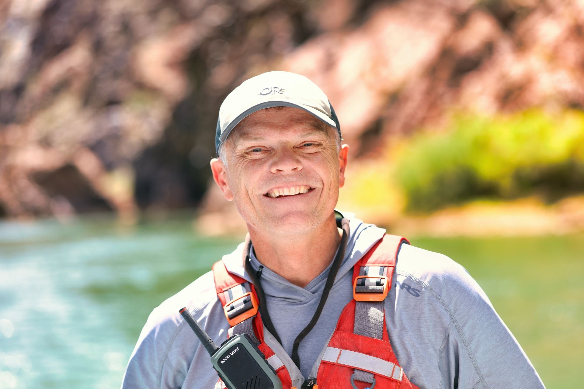 A river guide smiles while wearing a life jacket