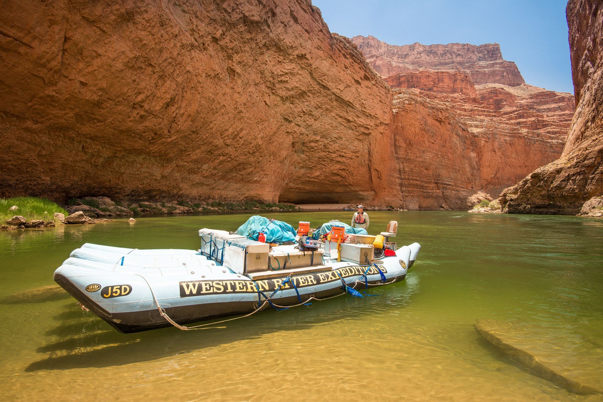 A J-Rig raft floating on calm river water