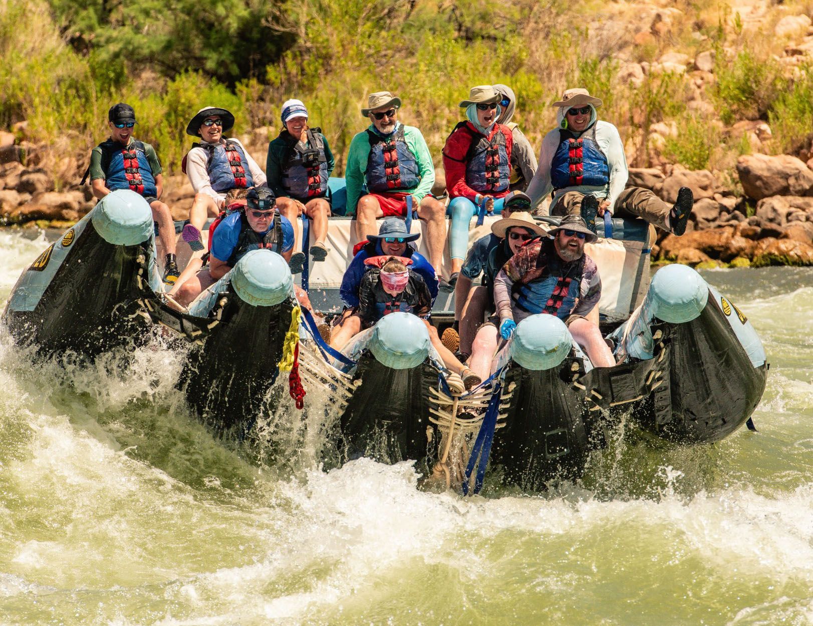 Guests at the front of a J-Rig ride down a whitewater wave