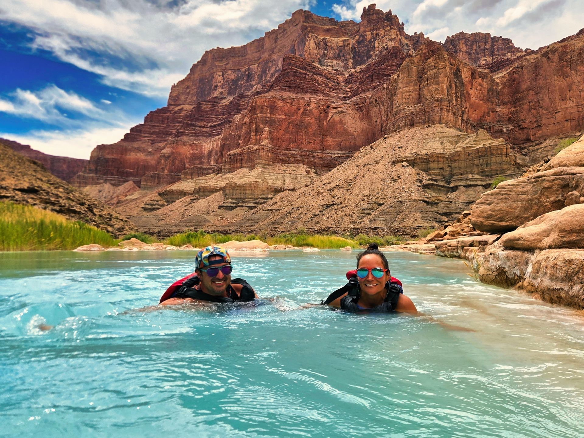 A couple floats in the turquoise water at the Little Colorado River confluence