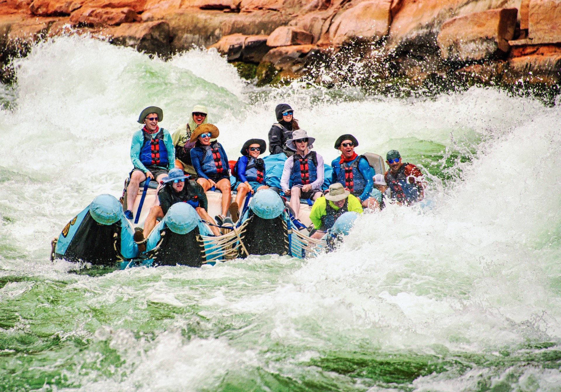 Rafters ride through foaming whitewater on a J-Rig