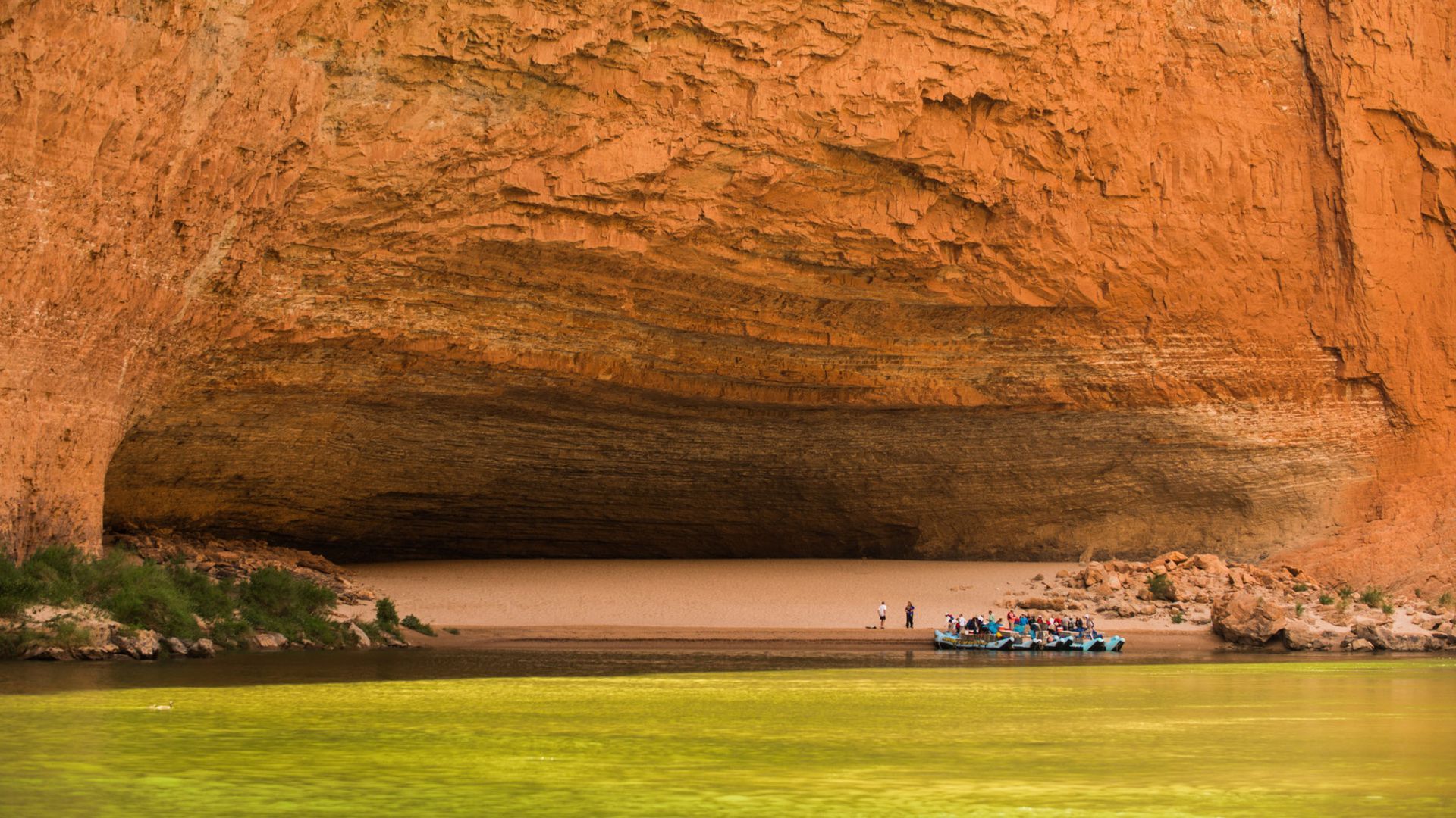 Rafts moored at the broad sandy beach beneath Redwall Cavern