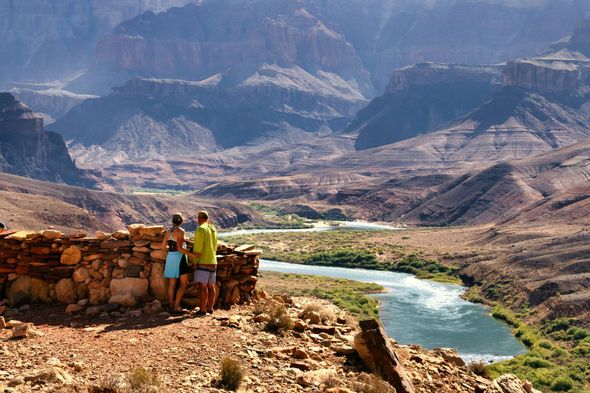 Two Western River guests looking out over Grand Canyon ruins above the Colorado River.