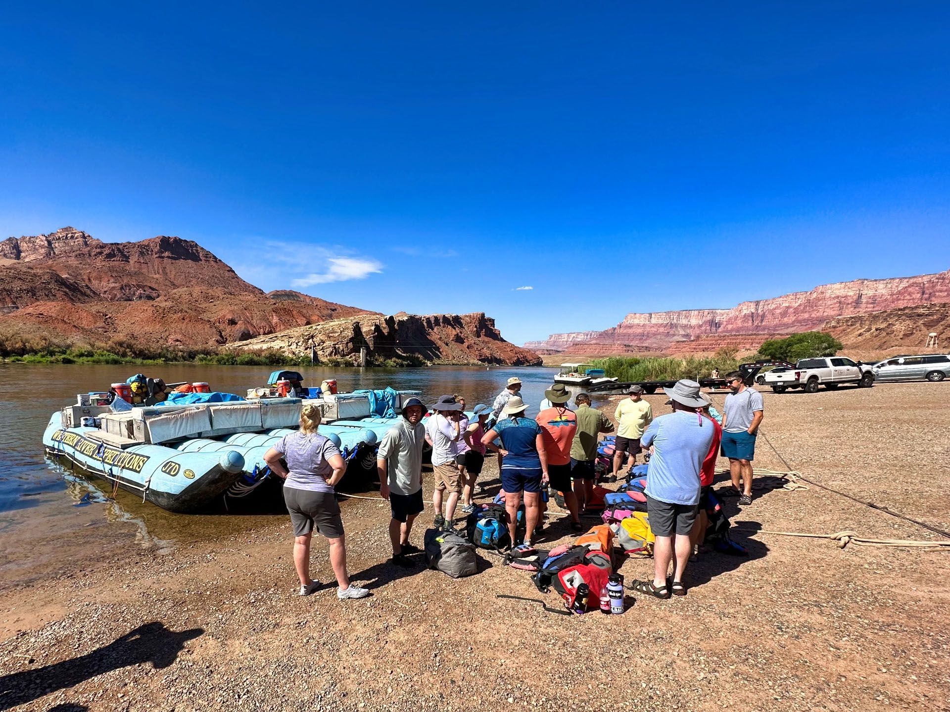 Guests gather beside rafts at Lees Ferry